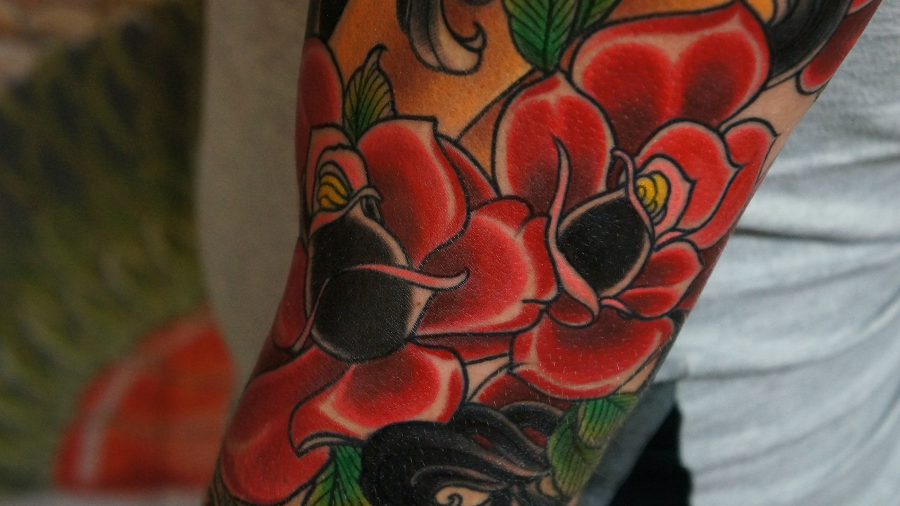 Red Roses traditional tattoo on sleeve