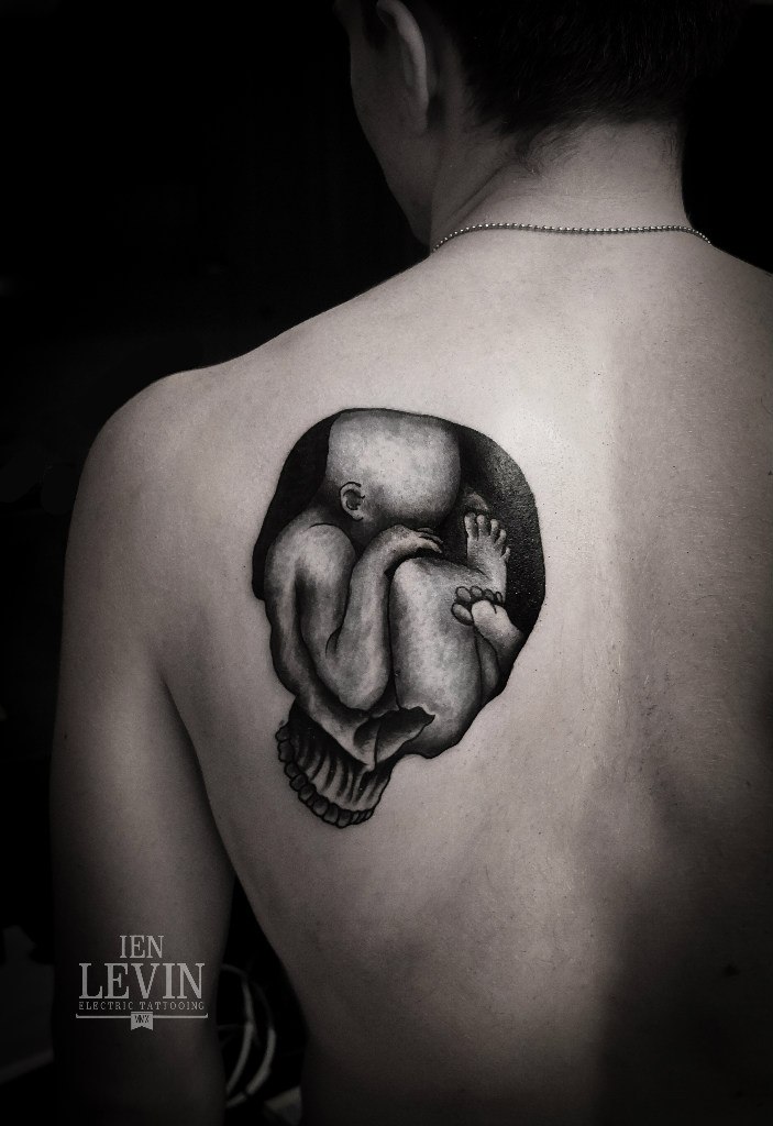 Baby in Scull Blackwork tattoo by Ien Levin