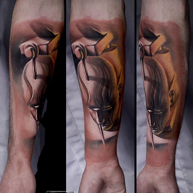 Nailed Puppet Head Tattoo on Arm