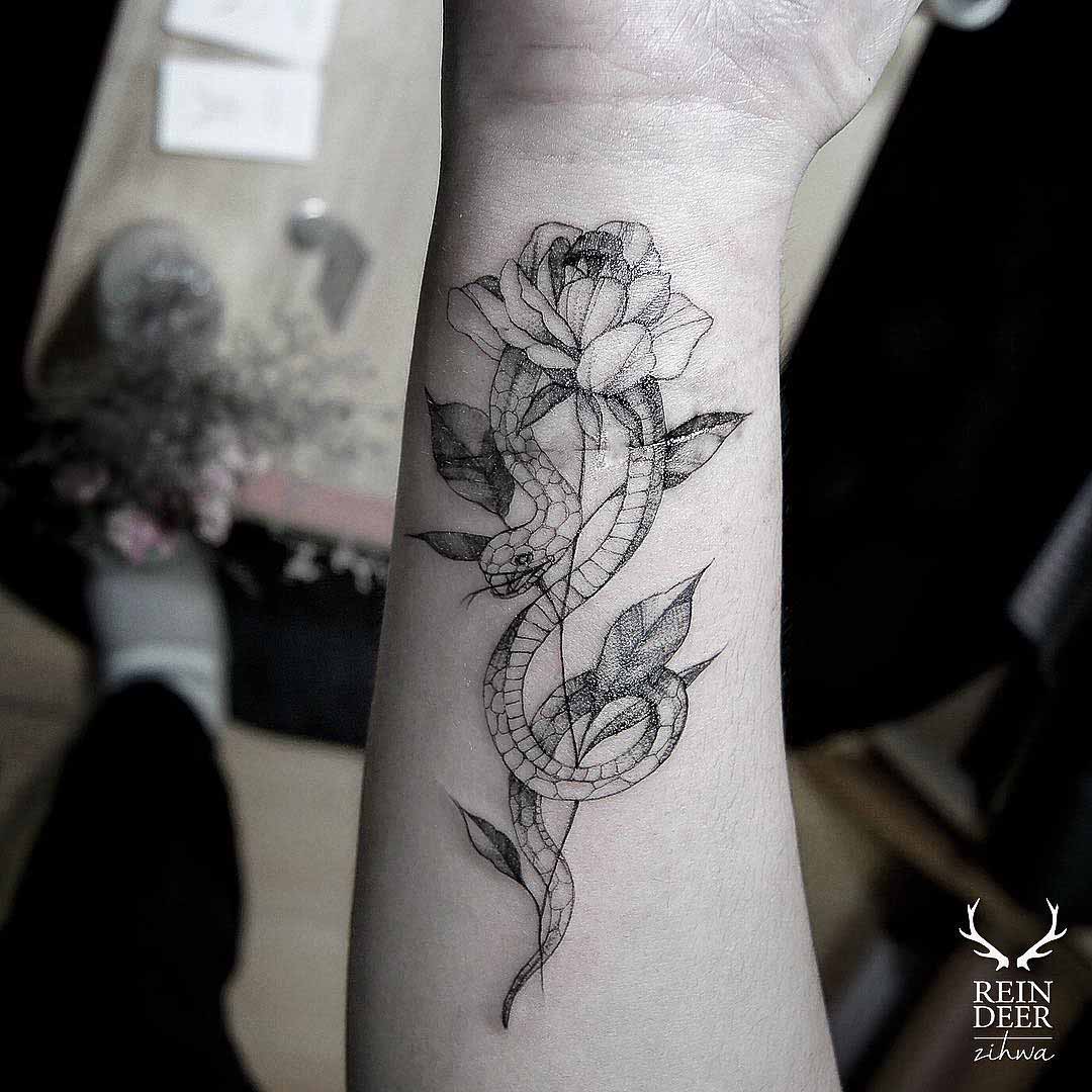 snake and rose tattoo on inner arm