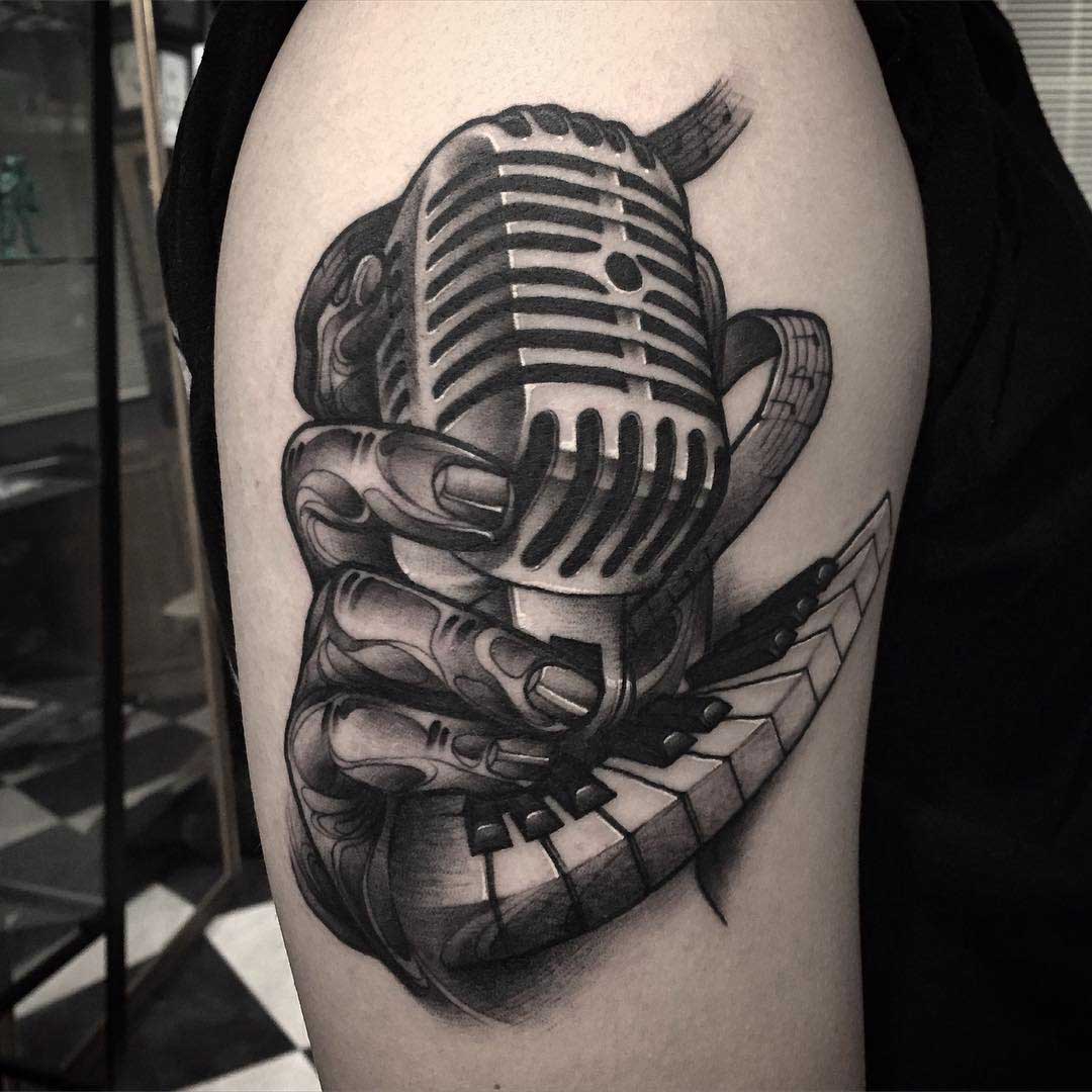 a vintage microphone tattoo on shoulder