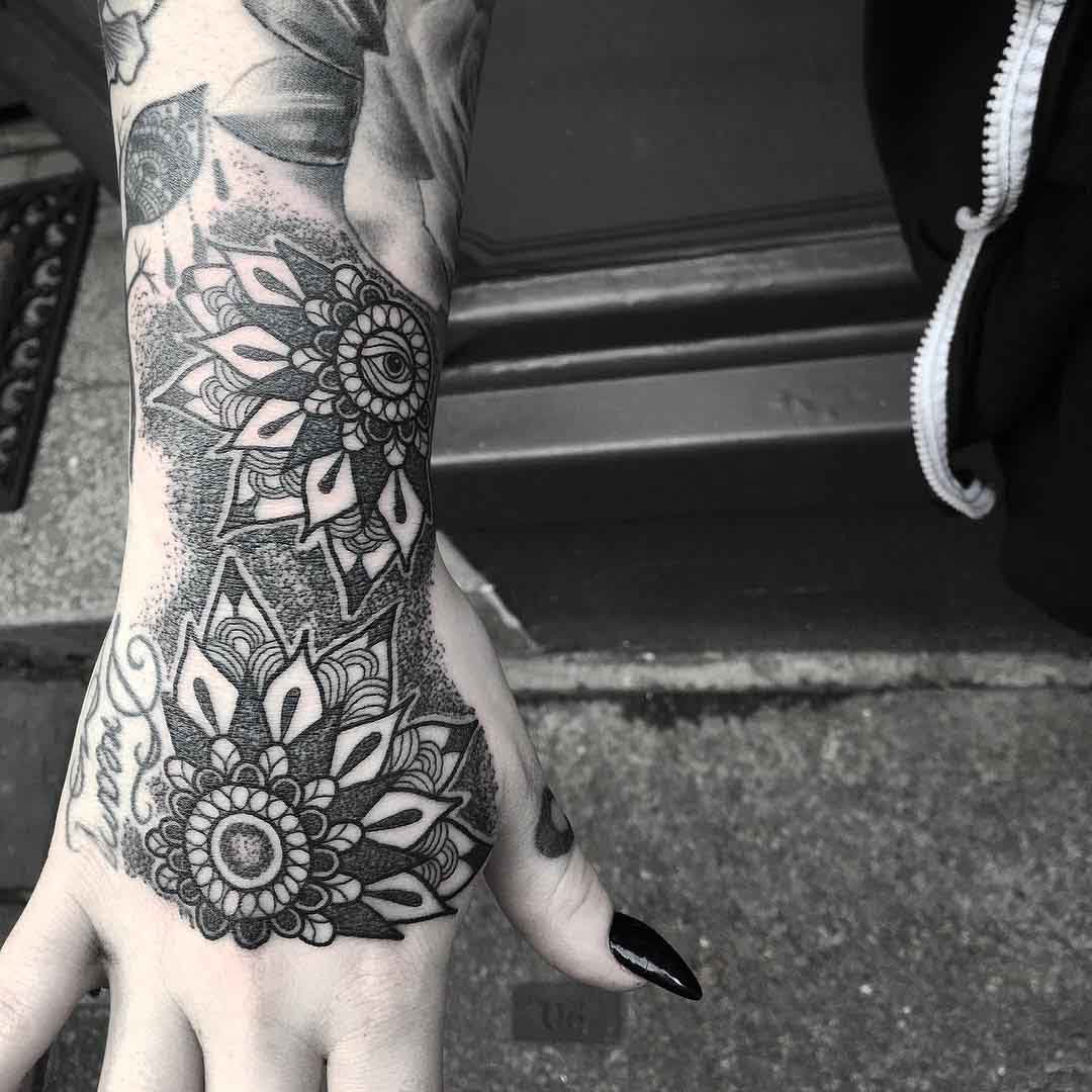 hand and wrist tattoos of mandalas