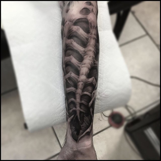 biomechanical tattoo on arm organic