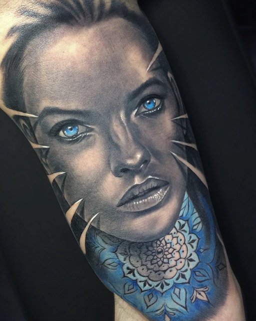 black and grey portrait tattoo witn blue eyse