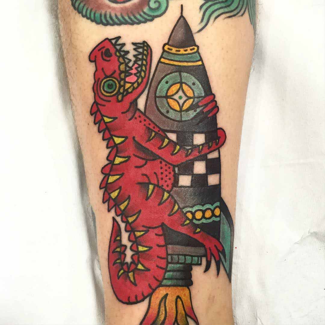 dinosaur tattoo on rocket