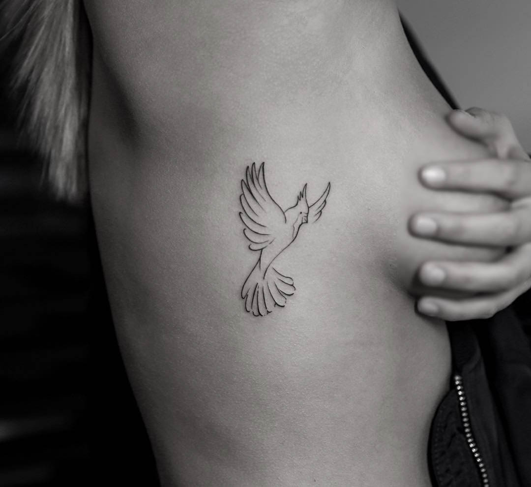 bird outline tattoo on ribs