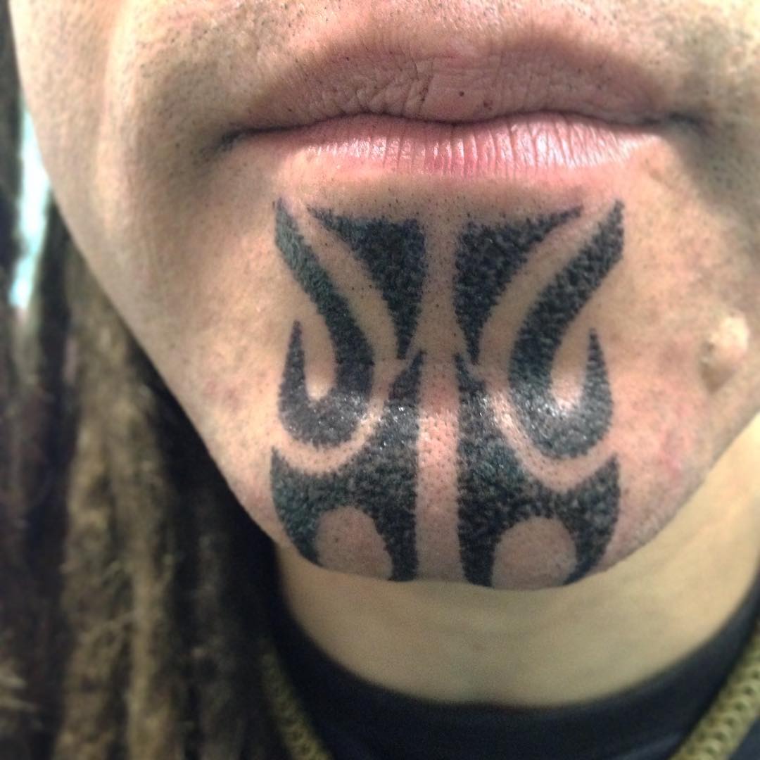 Tribal Chin Tattoo by aidaguidusbodyarts