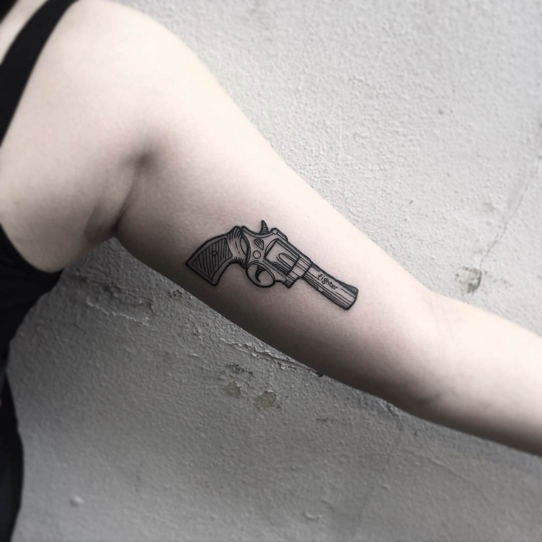 inner bicep tattoo pistol