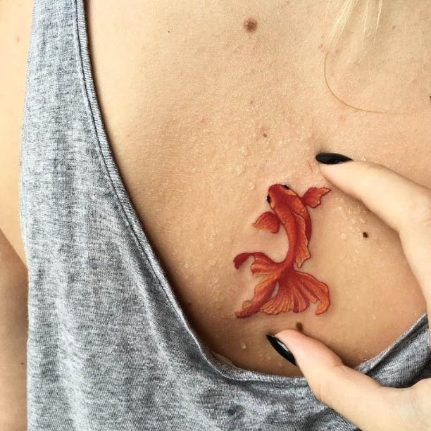 small gold fish tattoo