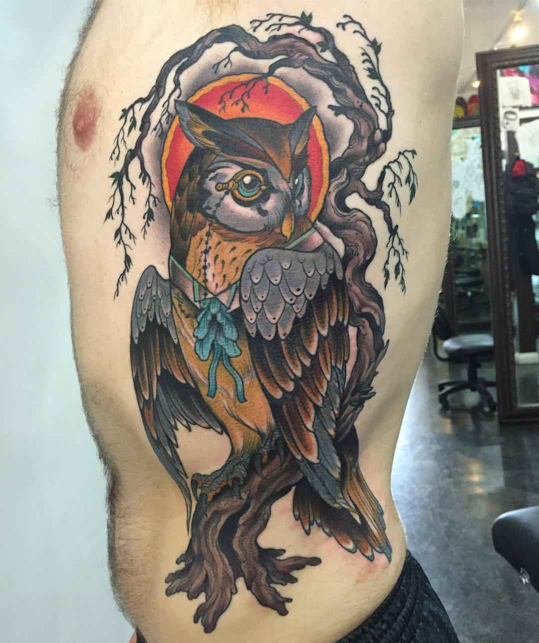 owl on a branch tattoo on the torso side