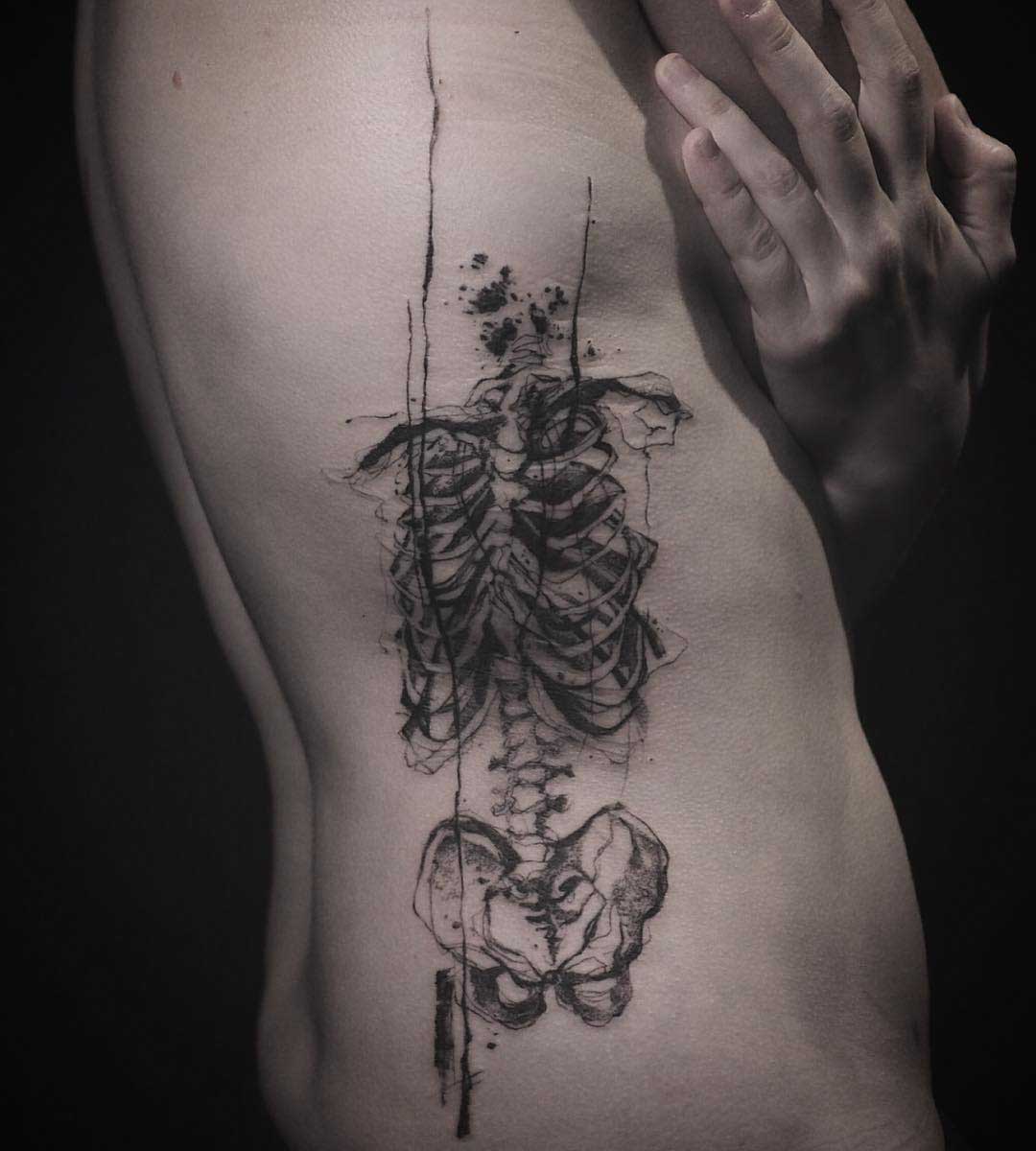 pencil drawn skeleton tattoo on ribs