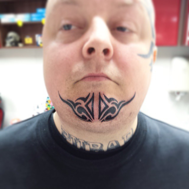 Tribal Chin Tattoo by madprof666