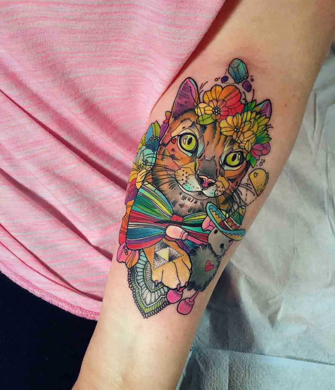 flowers cat tattoo on inner elbow