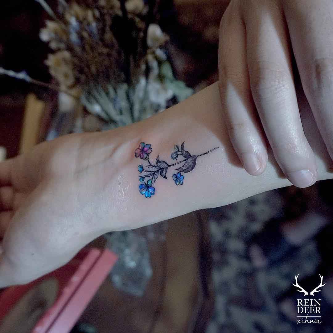 small flower tattoo on wrist