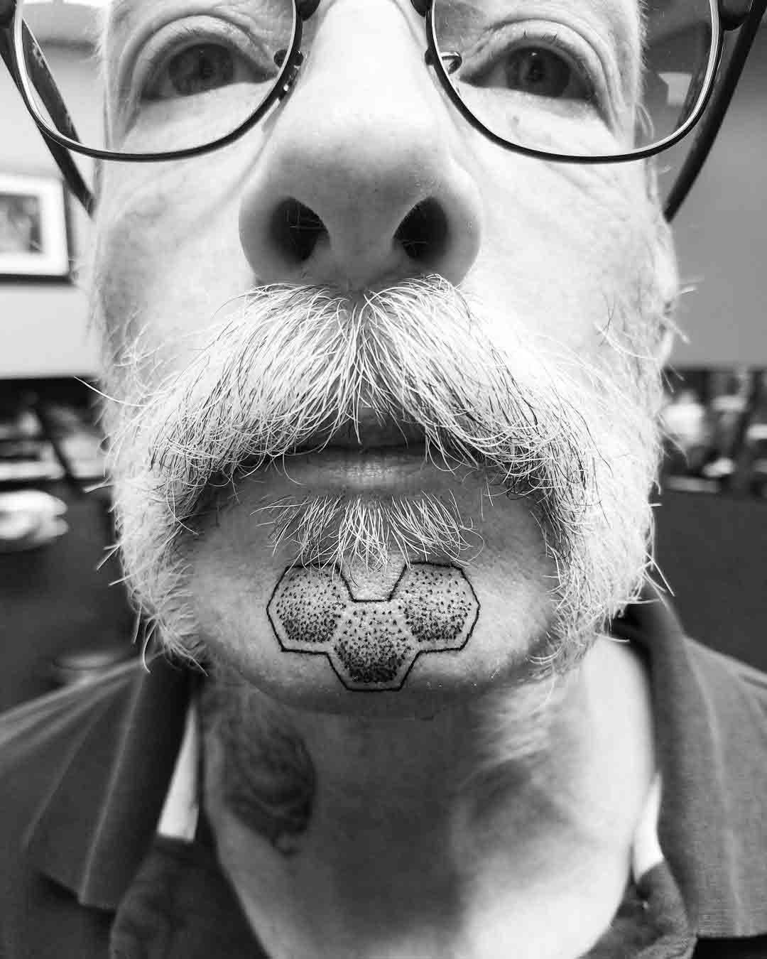 dotwork chin tattoo geometric pattern