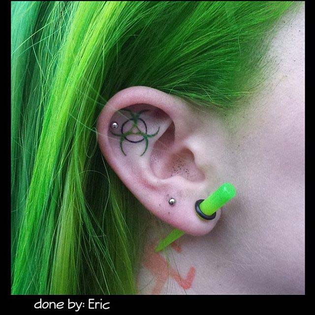 biohazzard sign tattoo on ear