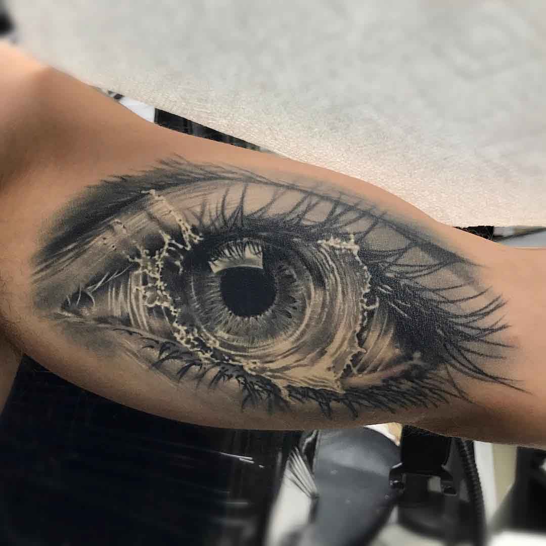 splash eye tattoo on bicep