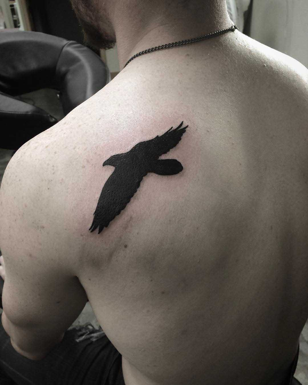 shoulder blade blackwork tattoo bird