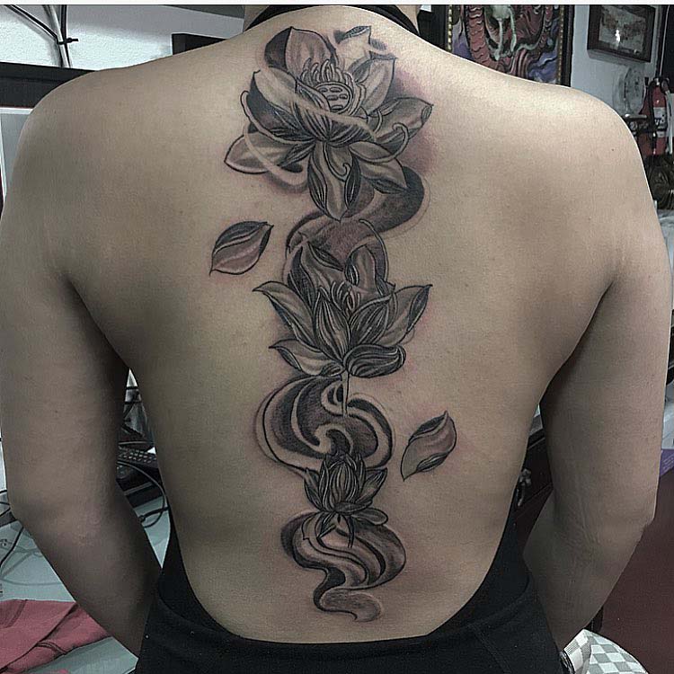 lotuses tattoo along spine