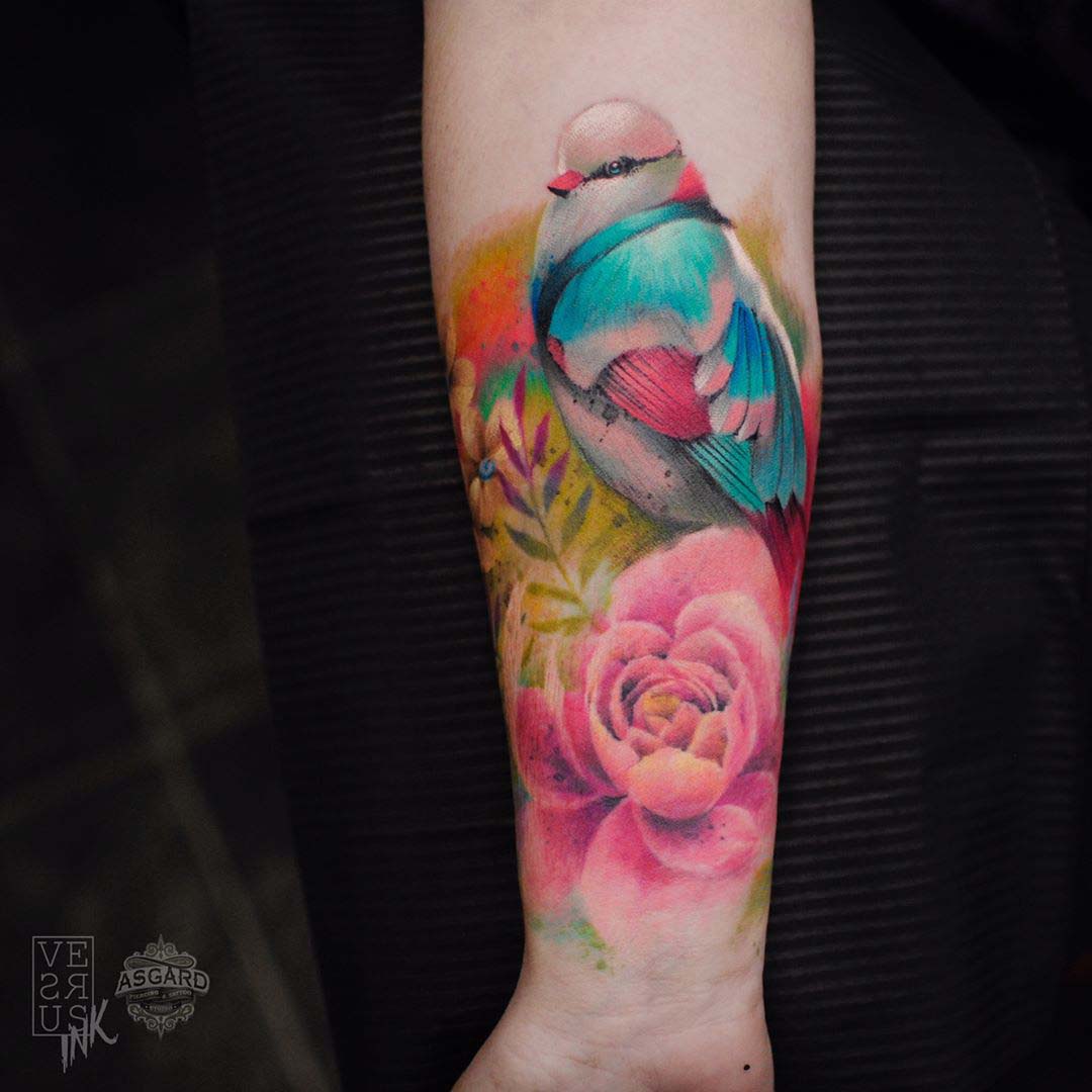 colorful bird tattoo on arm with flowers