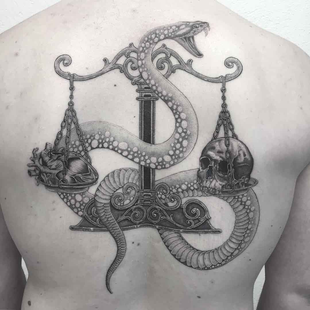 back tattoo snake and scales with hear and skull