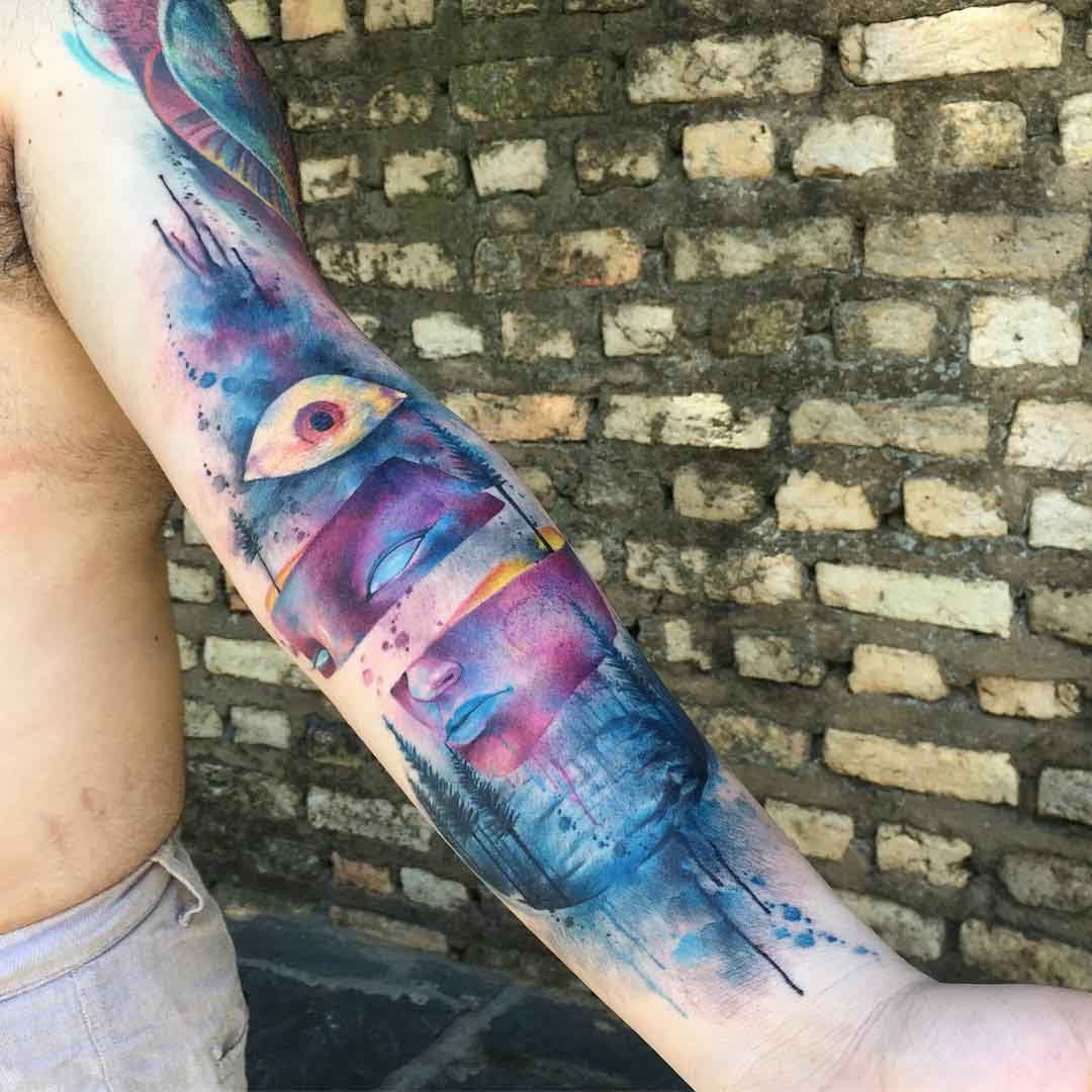 arm watercolor mask tattoo idea