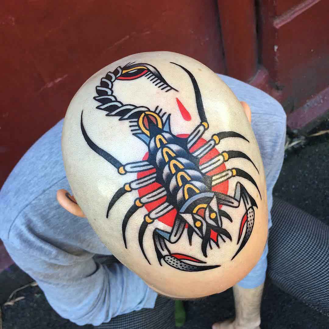 traditional scorpion tattoo on head