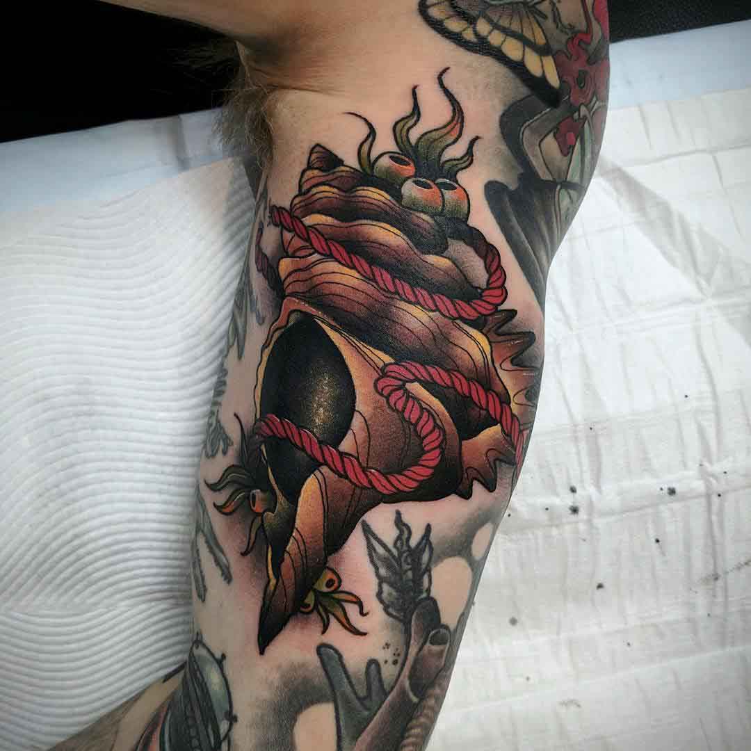 shell tattoo on bicep