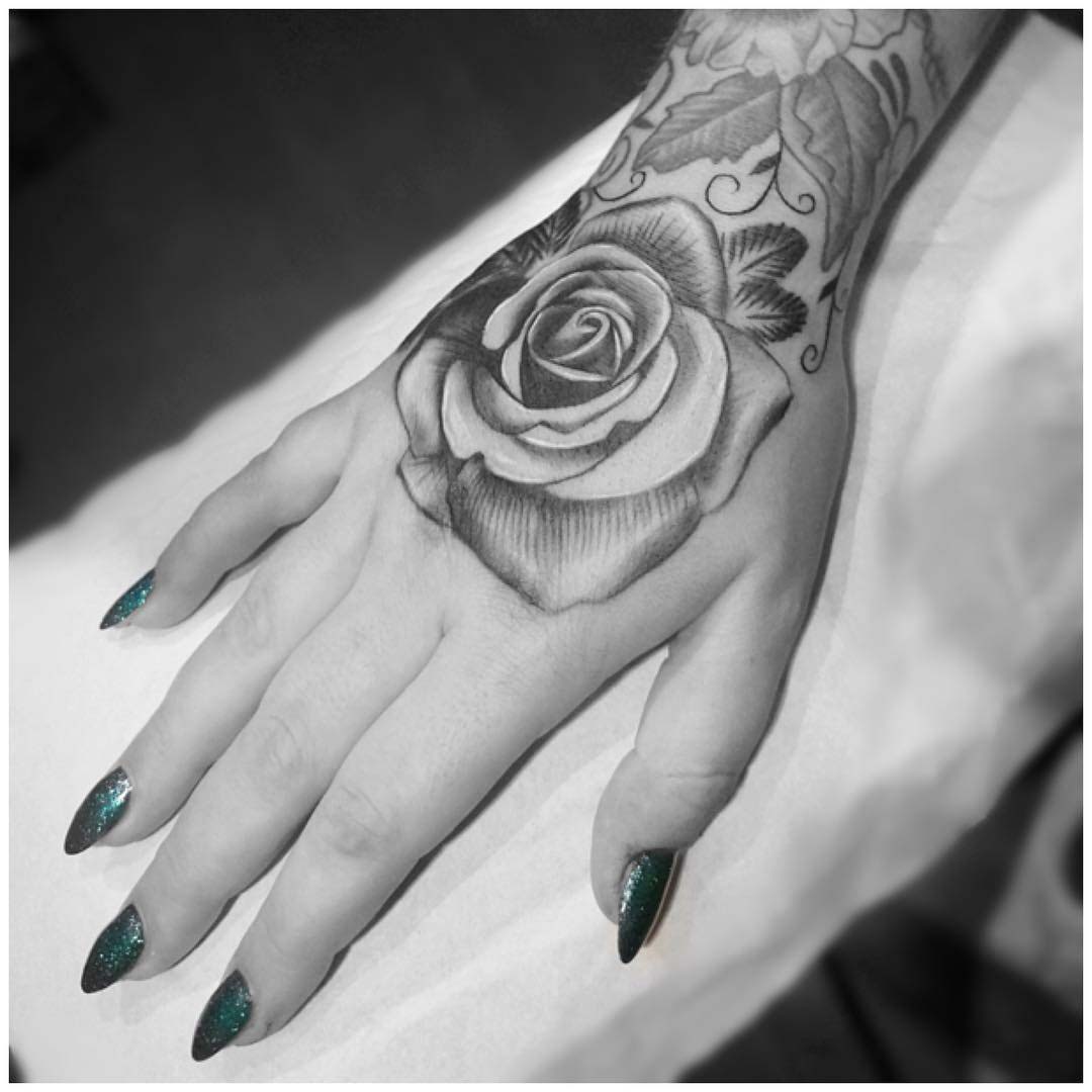 rose tattoo on hand