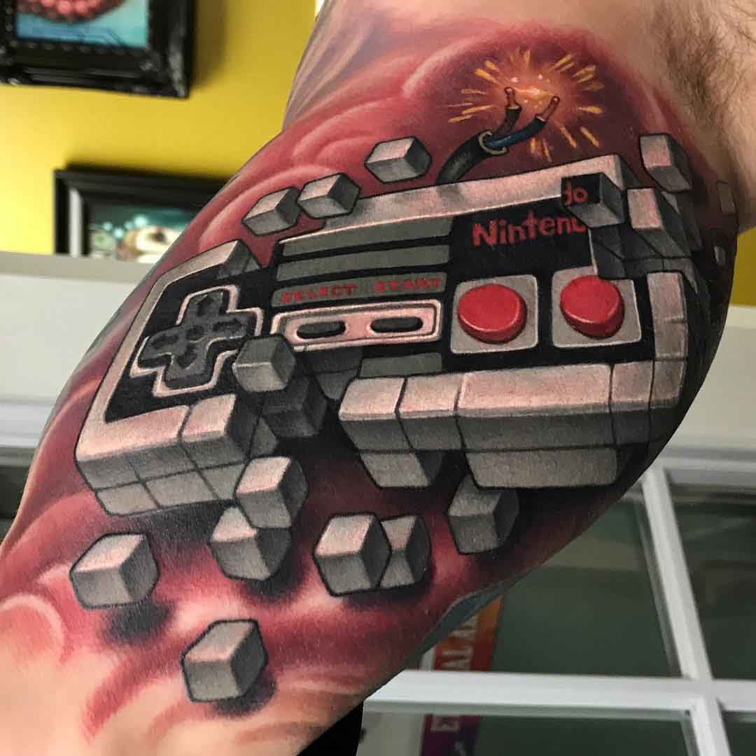 nintendo tattoo on bicep gamepad