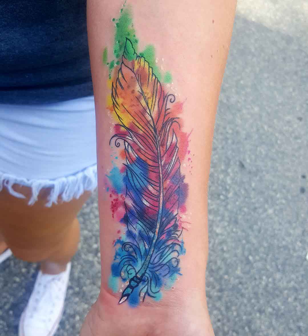 arm tattoo feather watercolor style