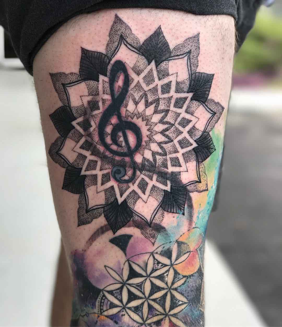 thigh tattoo treble clef in mandala