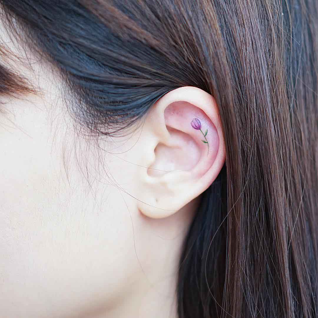 little tiny tulip tattoo on ear