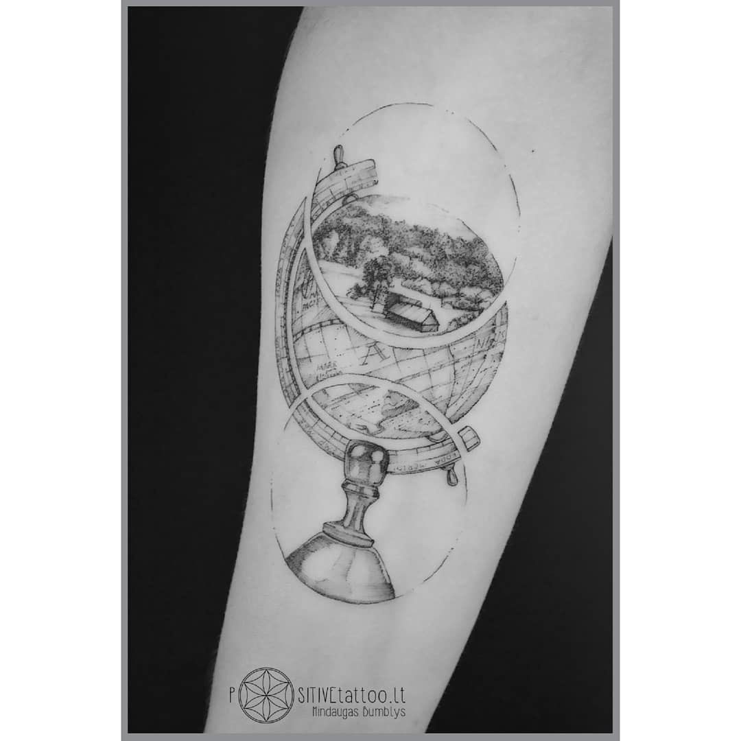 globe tattoo on arm lithuanian landscape