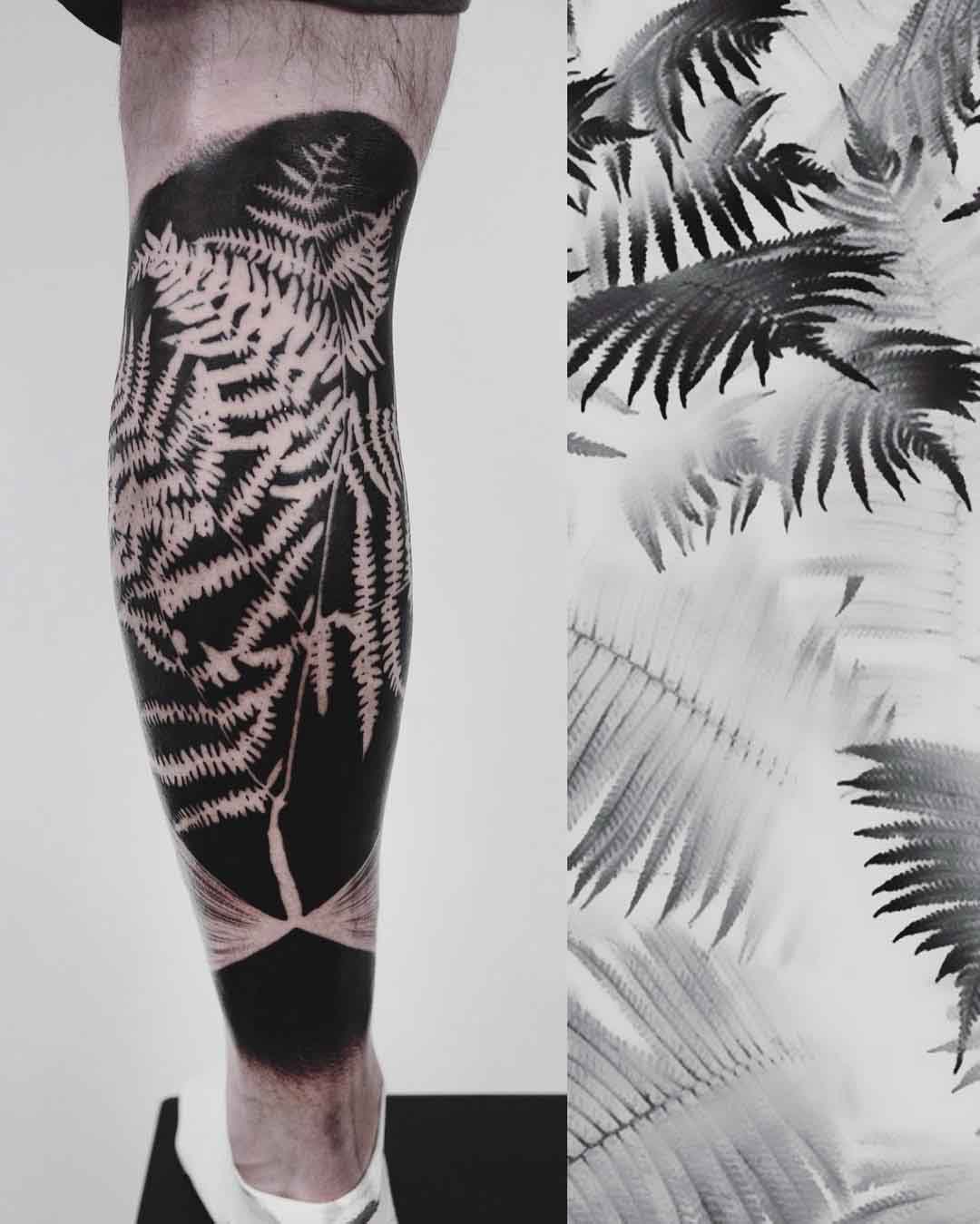 blackwork tattoo fern on calf